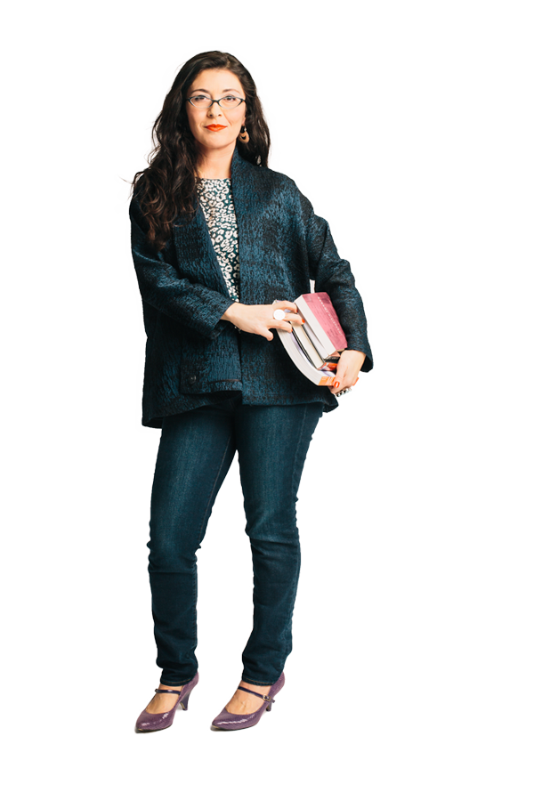 Tamara Toledo poses while holding a stack of books